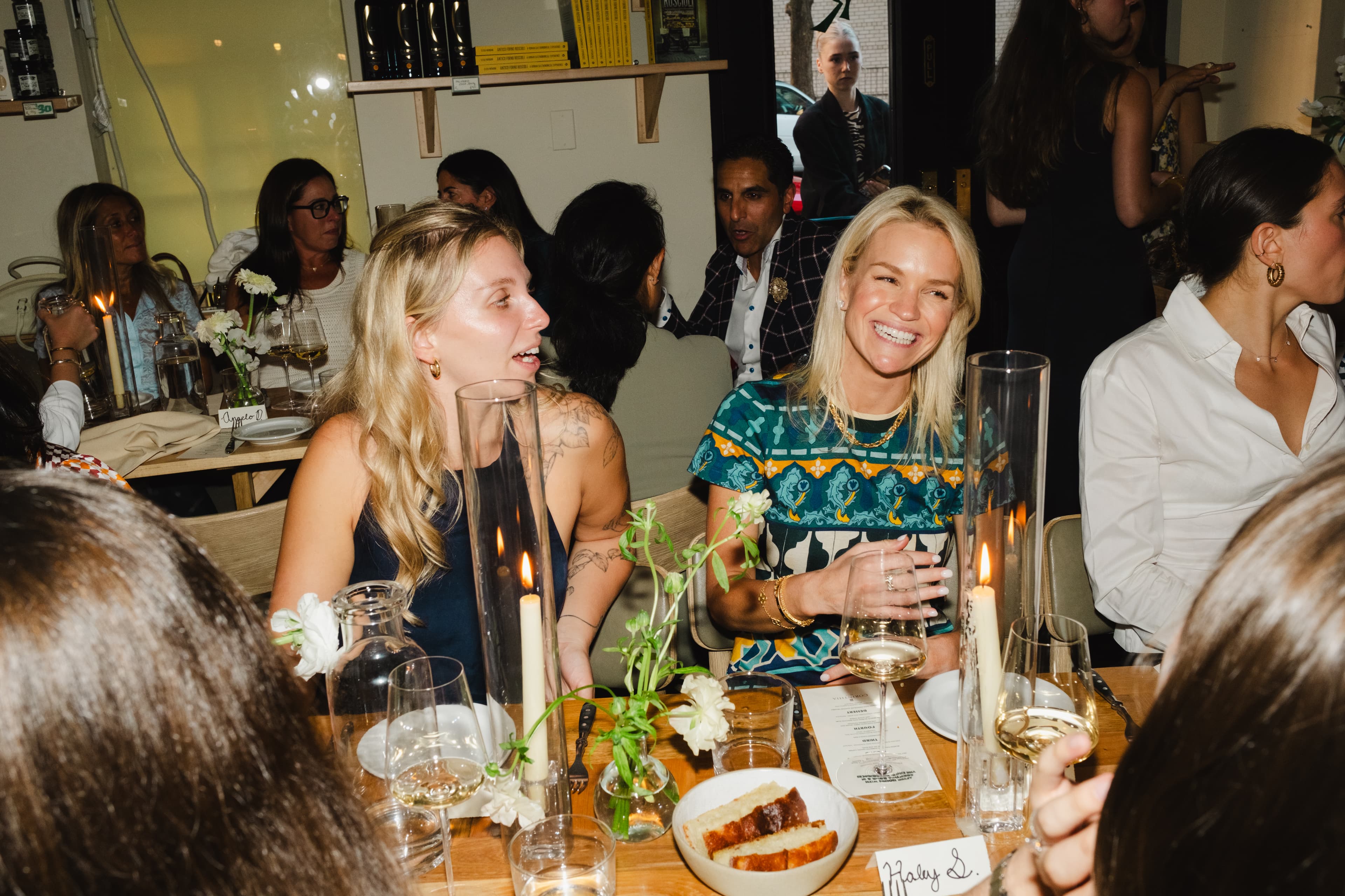 Guests gathered at an intimate candlelit dinner